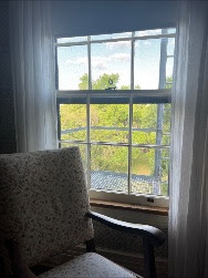 Chair by a window overlooking a forest