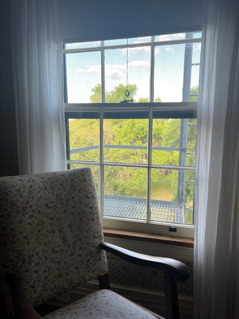 Chair by a window with light streaming in