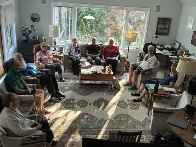 large group of people sitting in a U shape