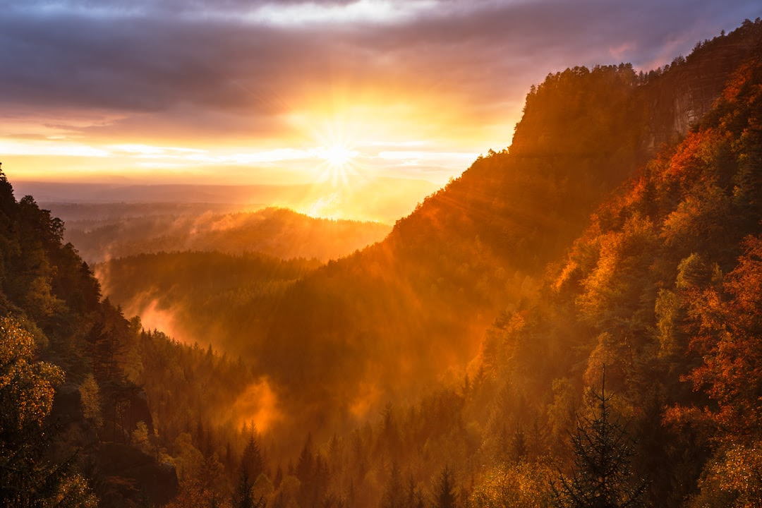 Mountain with a sun in the background